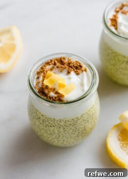 A cup of lemon chia pudding topped with yogurt, graham cracker crumbs, and a lemon twist.