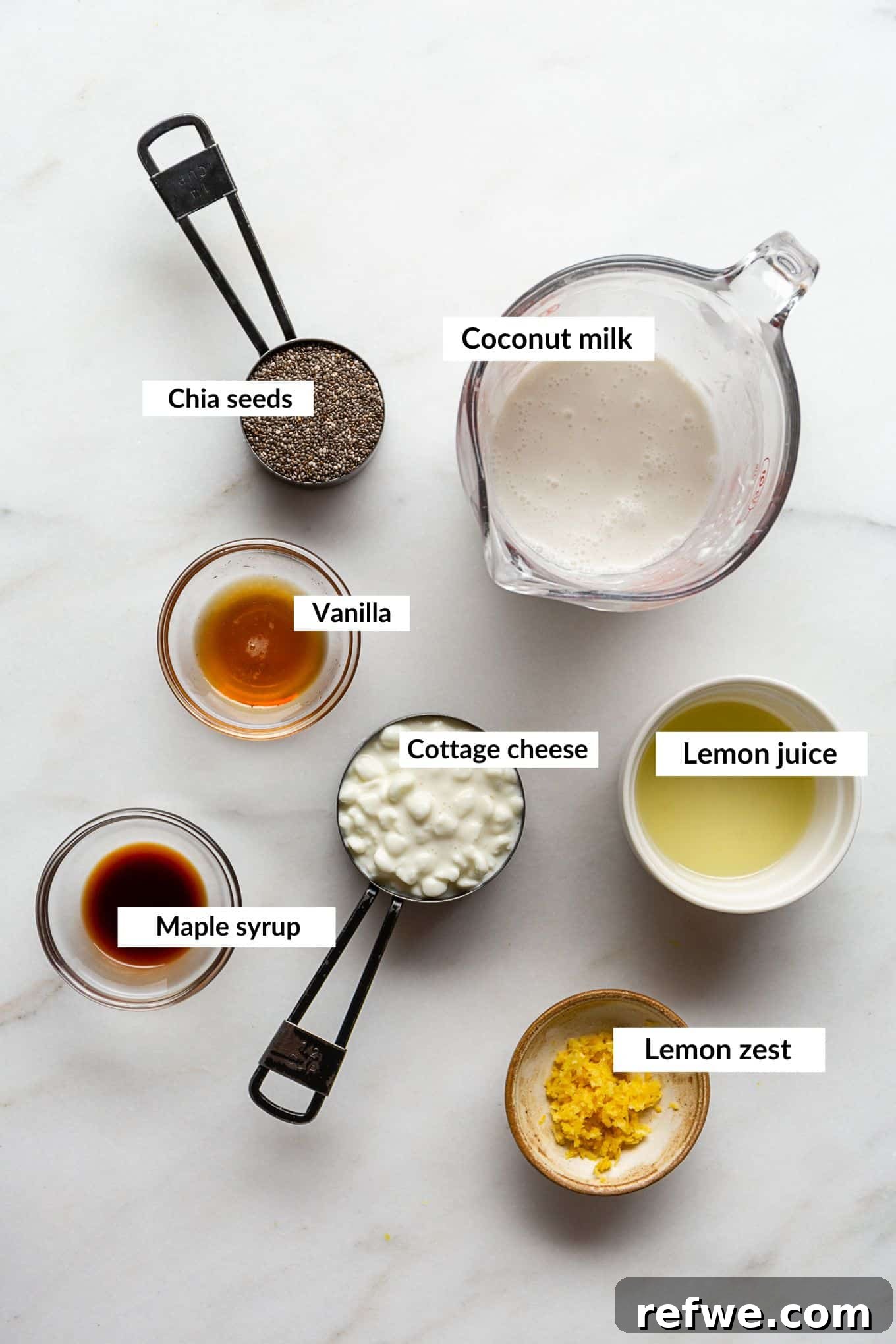 Sunshine Lemon Chia Pudding 3 A collection of ingredients laid out to make lemon chia pudding, including fresh lemons, chia seeds, cottage cheese, and coconut milk.