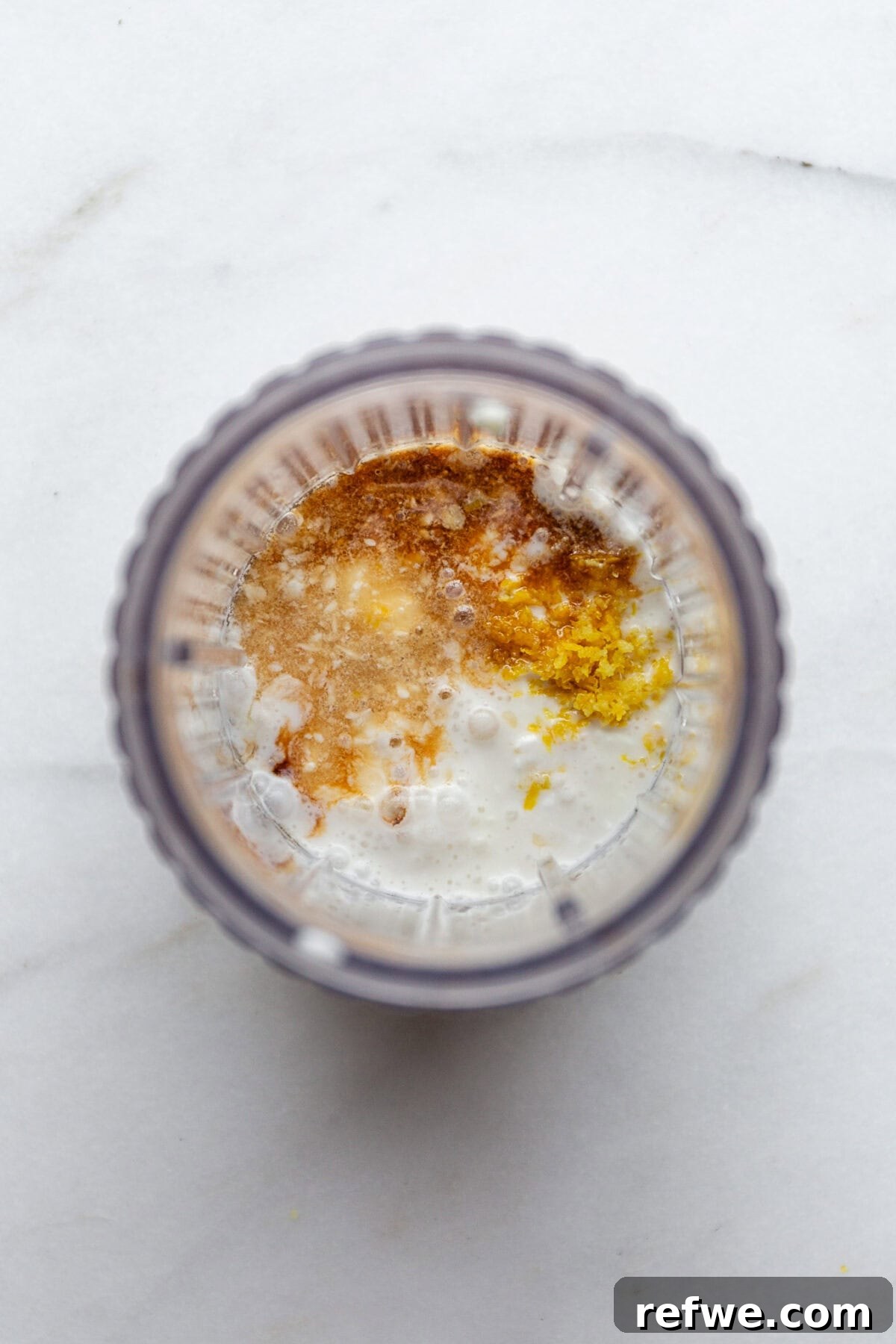 Sunshine Lemon Chia Pudding 4 Cottage cheese, coconut milk, lemon zest, and lemon juice in a blender container, ready to be blended.