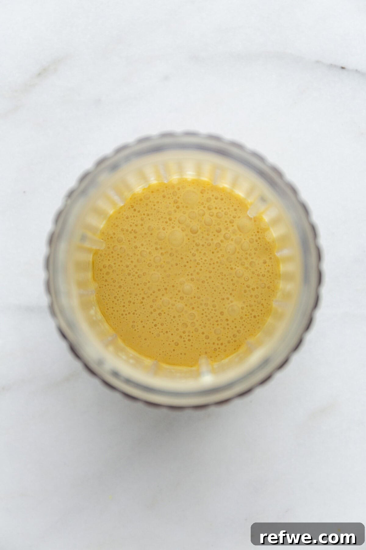 Sunshine Lemon Chia Pudding 5 Blended mixture of cottage cheese, coconut milk, lemon zest, and lemon juice in a blender container, showing a smooth, creamy texture.