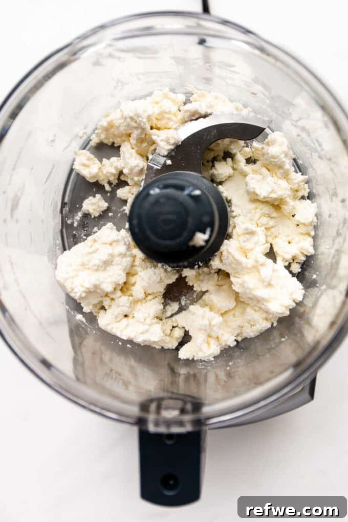 Pillowy Ricotta Toast 3 Fresh ricotta cheese, olive oil, and salt in a food processor, ready for blending.