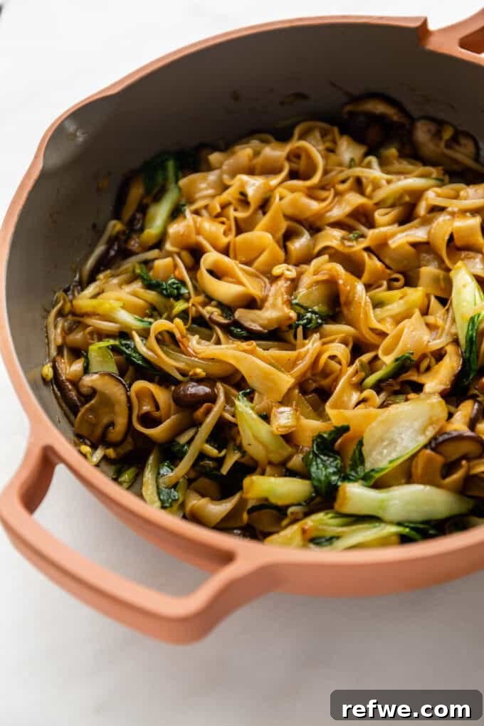 Wok-Tossed Ho Fun 10 A large pan filled with freshly stir-fried Ho Fun Noodles, perfectly cooked and ready for serving.