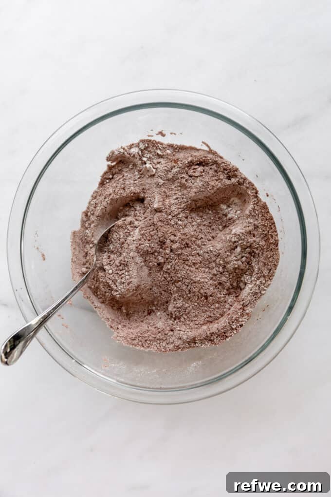 Wholesome Cocoa Zucchini Muffins 6 Flour and cocoa powder perfectly mixed together in a clear bowl.