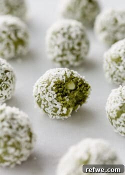 matcha bites on a marble counter, a close-up showcasing the green color and coconut coating