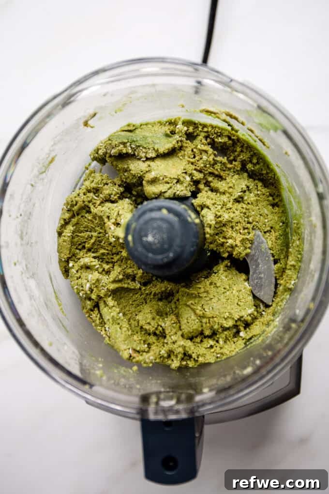 Zen Matcha Fuel Bites 4 matcha energy ball dough in a food processor, showing a smooth, green mixture