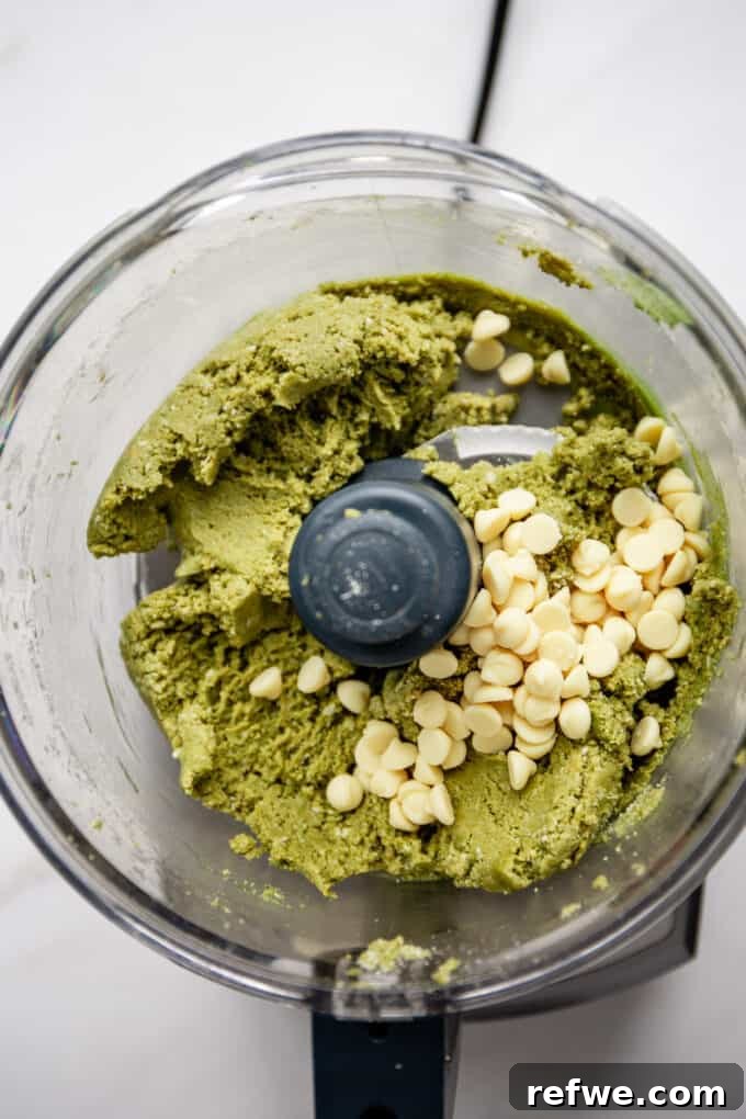 Zen Matcha Fuel Bites 5 matcha energy balls dough and white chocolate chips in a food processor, partially mixed