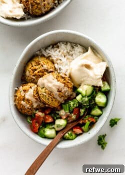 A falafel bowl with Israeli salad and hummus, ready to be enjoyed