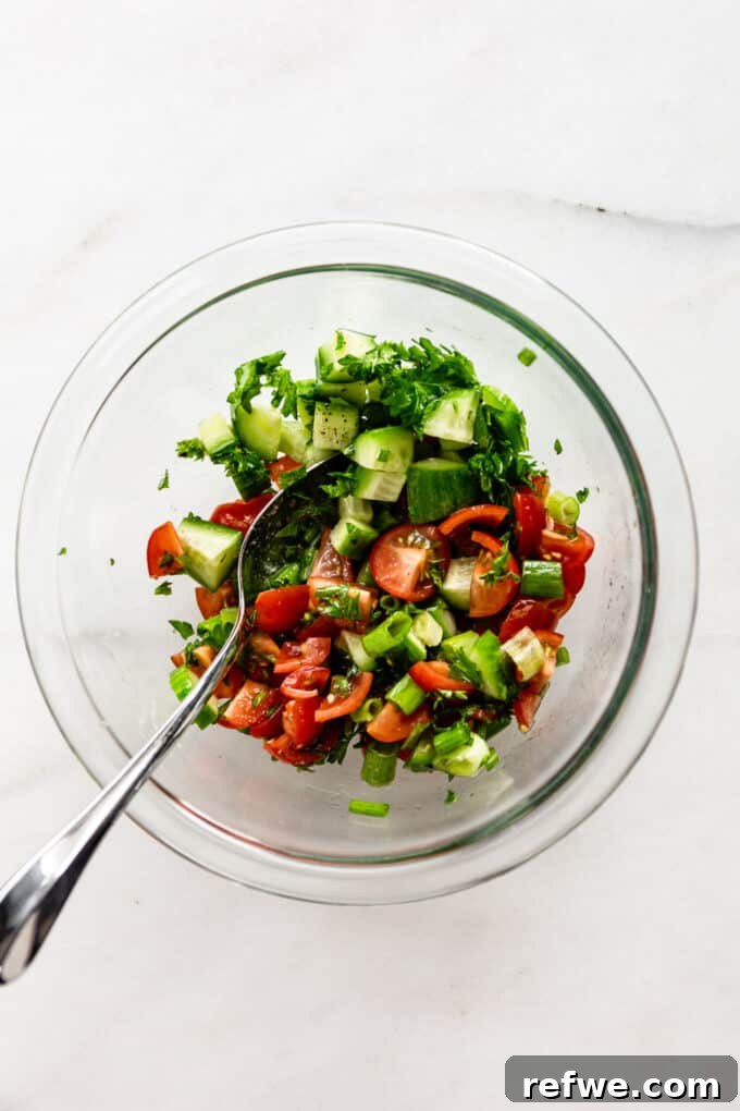 Quick Oven-Baked Falafel Bowls 8 Vibrant Israeli salad freshly mixed in a clear bowl