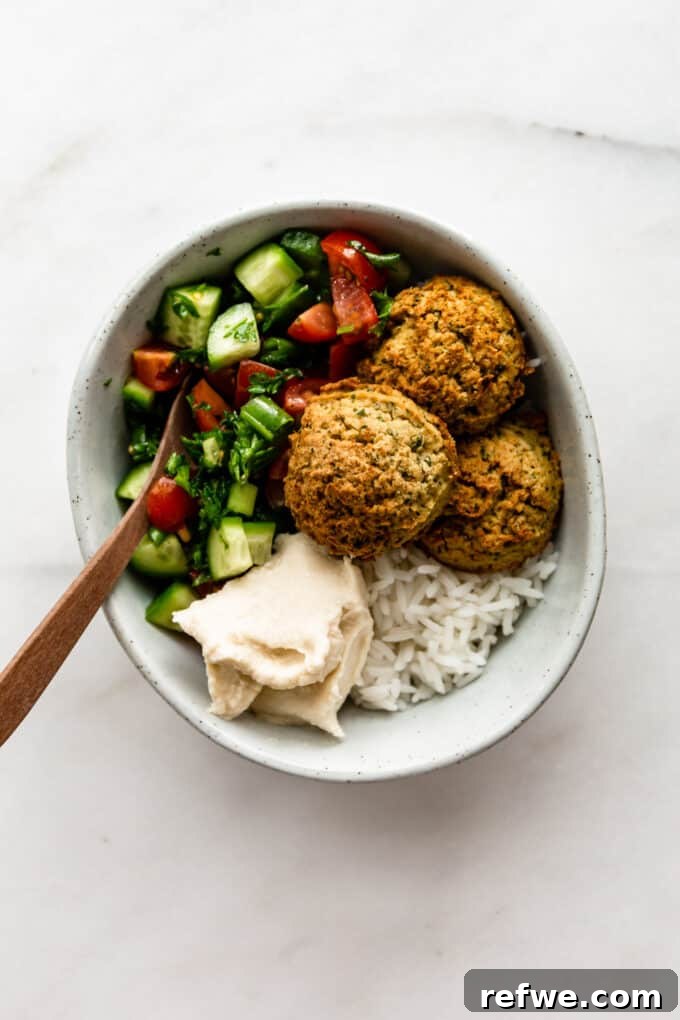 Quick Oven-Baked Falafel Bowls 10 Fully assembled falafel bowl with falafel, salad, rice, and hummus