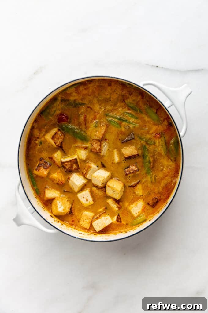 Quick and Creamy Thai Massaman 10 Crispy tofu and colorful vegetables stirred into a luscious Massaman curry sauce in a pot, ready to serve.