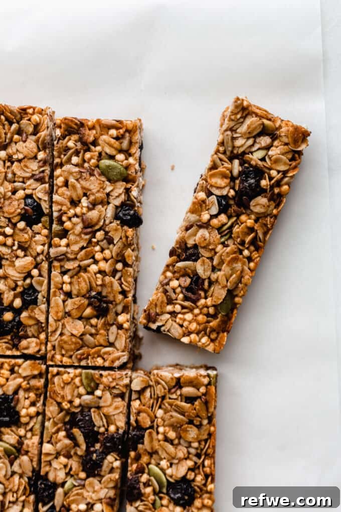 Nourishing Homemade Granola Bars 2 sliced homemade granola bars on parchment paper