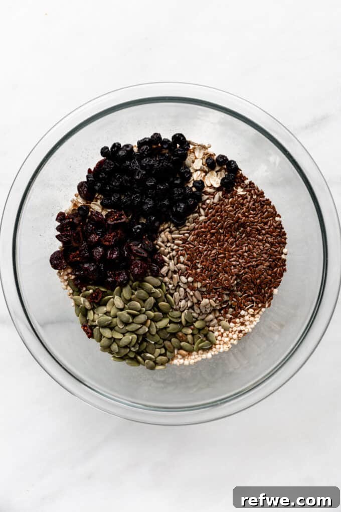 Nourishing Homemade Granola Bars 6 oats, puffed quinoa, flax seeds, pumpkin seeds and dried fruit in a clear bowl