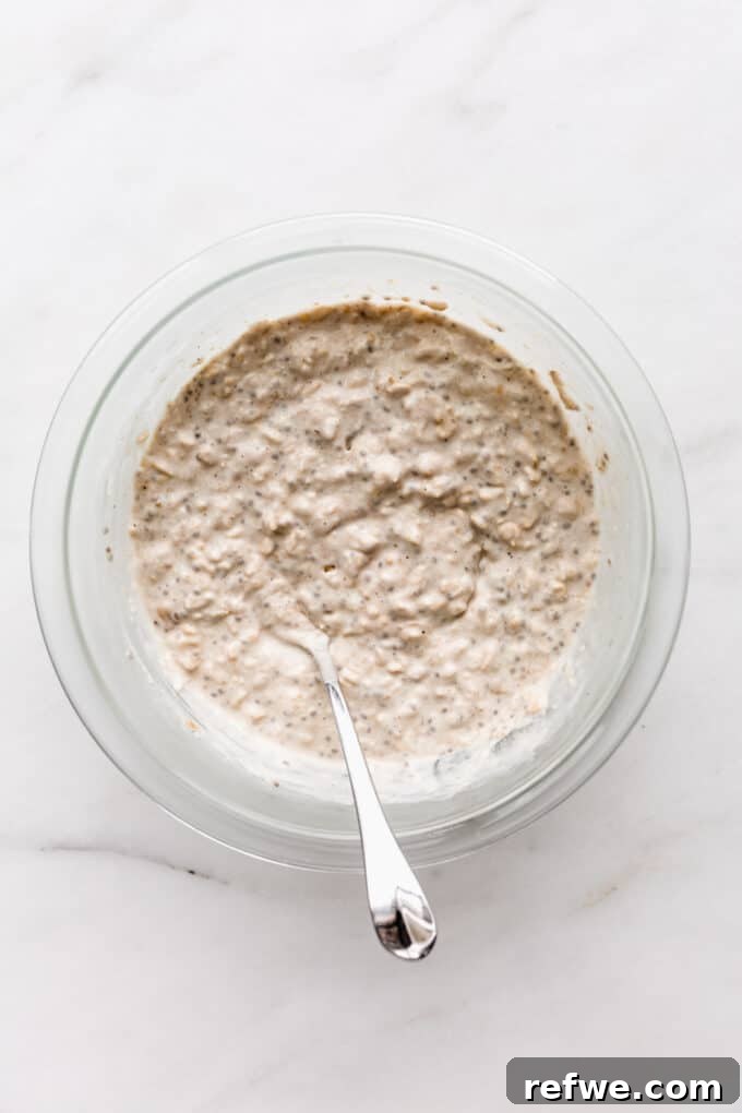 No-Bake Apple Pie Oats 7 A large bowl of banana overnight oats, covered and placed in the fridge, illustrating the setting process.