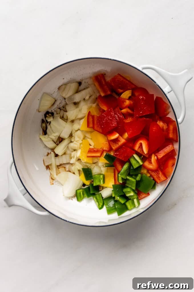 Hearty Sweet Potato Black Bean Chili 5 Diced bell pepper and jalapeño added to the onions and garlic, continuing to sauté in the white pot.