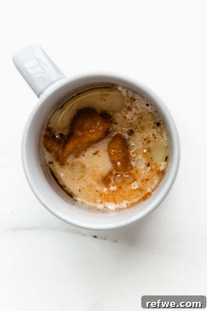 Warm Pumpkin Spice Mug Bliss 4 Wet ingredients: pumpkin puree, oil, almond milk, and vanilla extract added to the mug