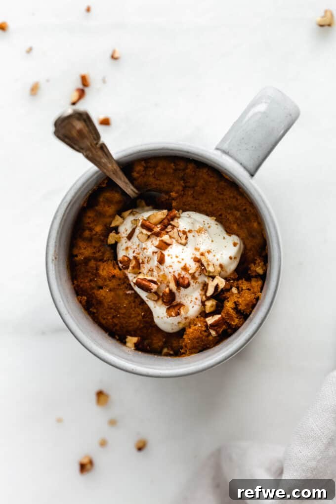Warm Pumpkin Spice Mug Bliss 6 Finished pumpkin cake in a mug, generously topped with whipped cream and chopped pecans