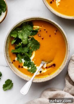 butternut squash sweet potato soup topped with cilantro and chili flakes