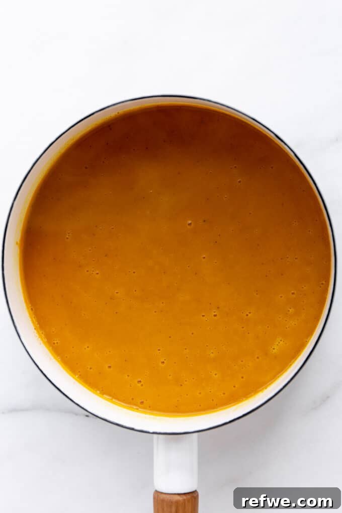 creamy, blended butternut squash sweet potato soup in a pot, ready to serve