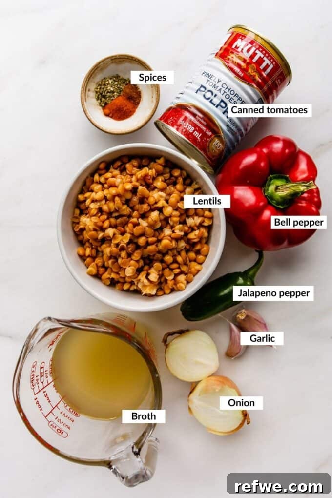 A vibrant selection of fresh ingredients laid out for making lentil chili, including bell peppers, onions, garlic, and spices.
