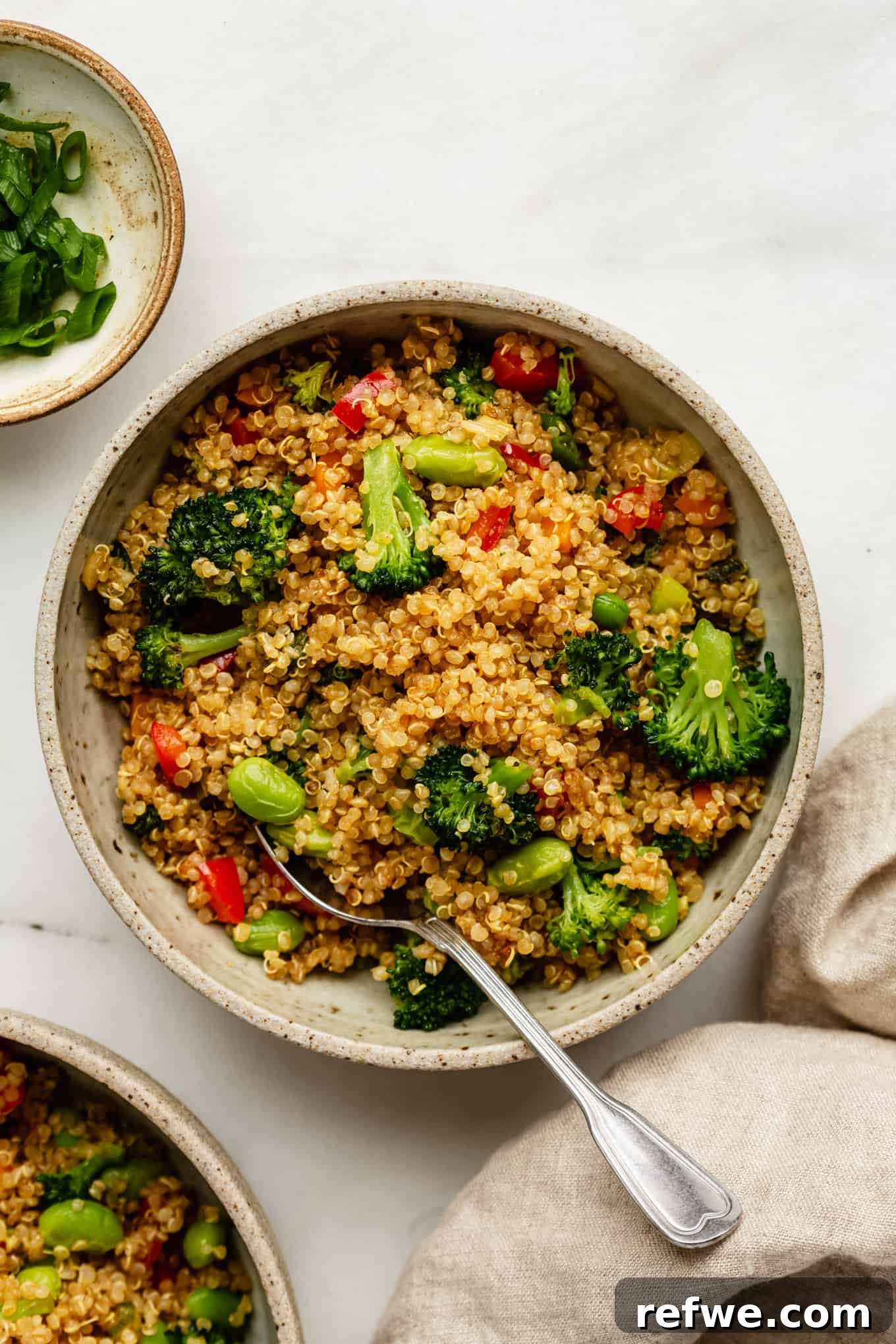 Wholesome Quinoa Stir-Fry 2 A colorful bowl of Quinoa Fried Rice with mixed vegetables and a spoon, ready to be enjoyed.