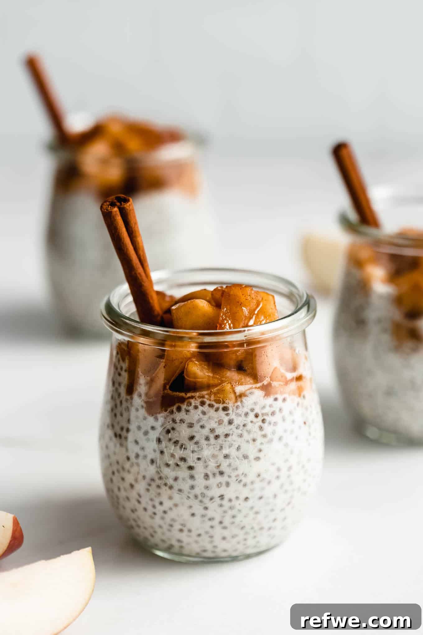 Four charming jars of apple pie chia pudding, beautifully layered and ready to be served or stored.