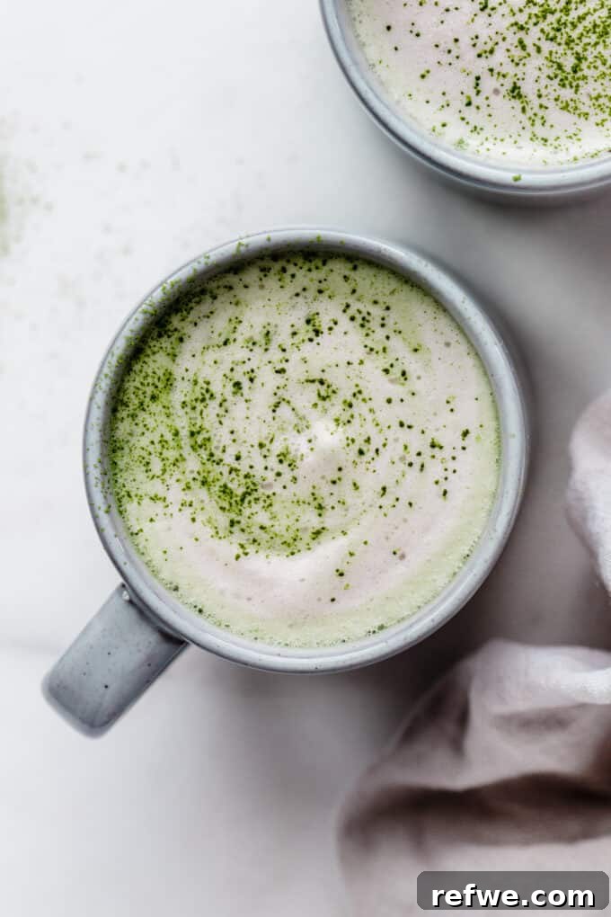 A serene matcha latte in a blue mug, perfectly frothed and ready to enjoy.