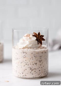 a cup of chai latte overnight oats topped with whipped cream