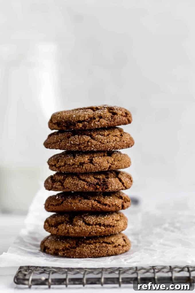 Festive & Fit: 18 Healthier Holiday Treats 3 Perfectly baked Chewy Ginger Molasses Cookies, featuring a crinkled exterior and rich, spiced aroma, ideal for festive healthy holiday baking.