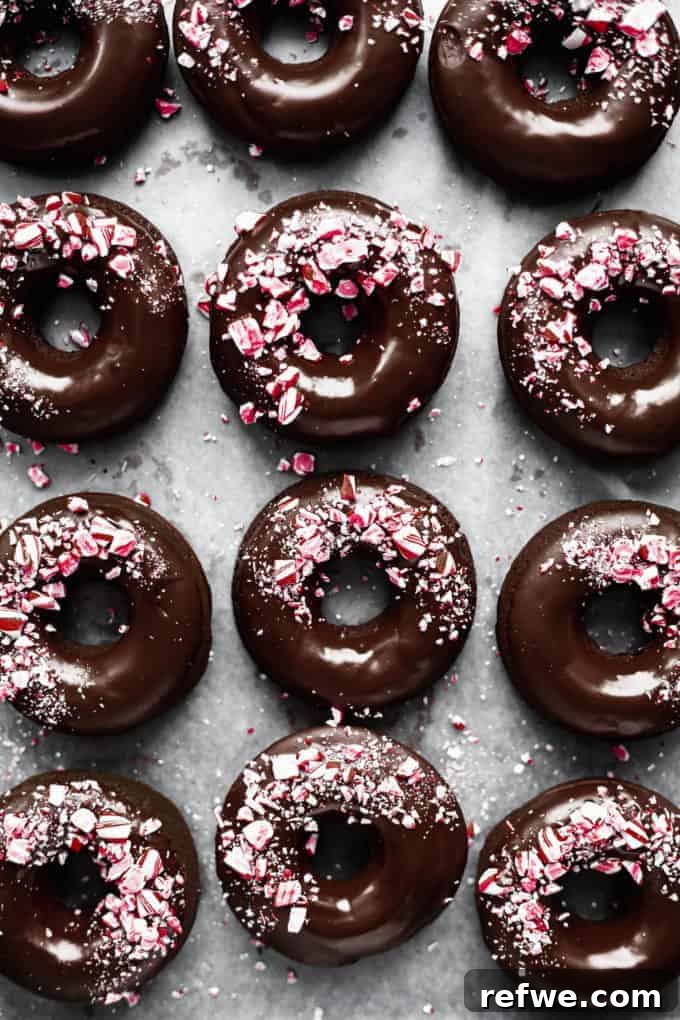 Festive & Fit: 18 Healthier Holiday Treats 7 Festive Vegan Peppermint Mocha Donuts, glazed with chocolate and topped with candy cane pieces, a delicious healthy holiday dessert.