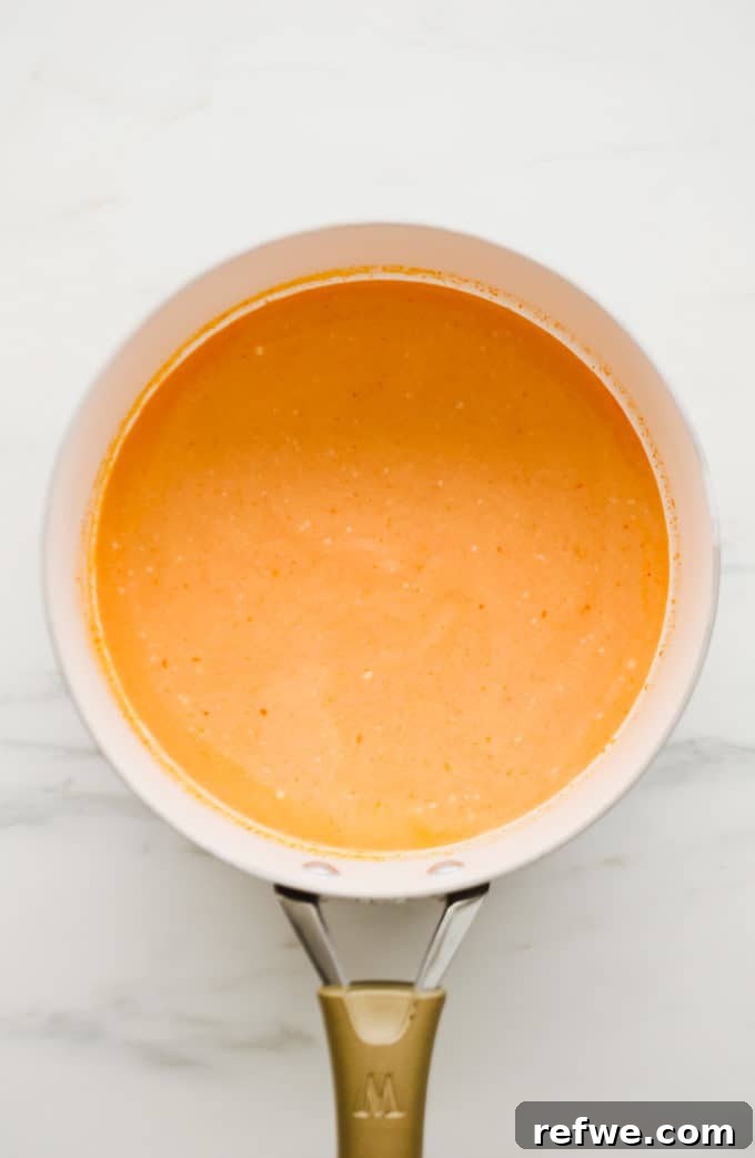 Spicy Thai Red Curry Noodles 7 Creamy red curry sauce in a white pan, ready for noodles