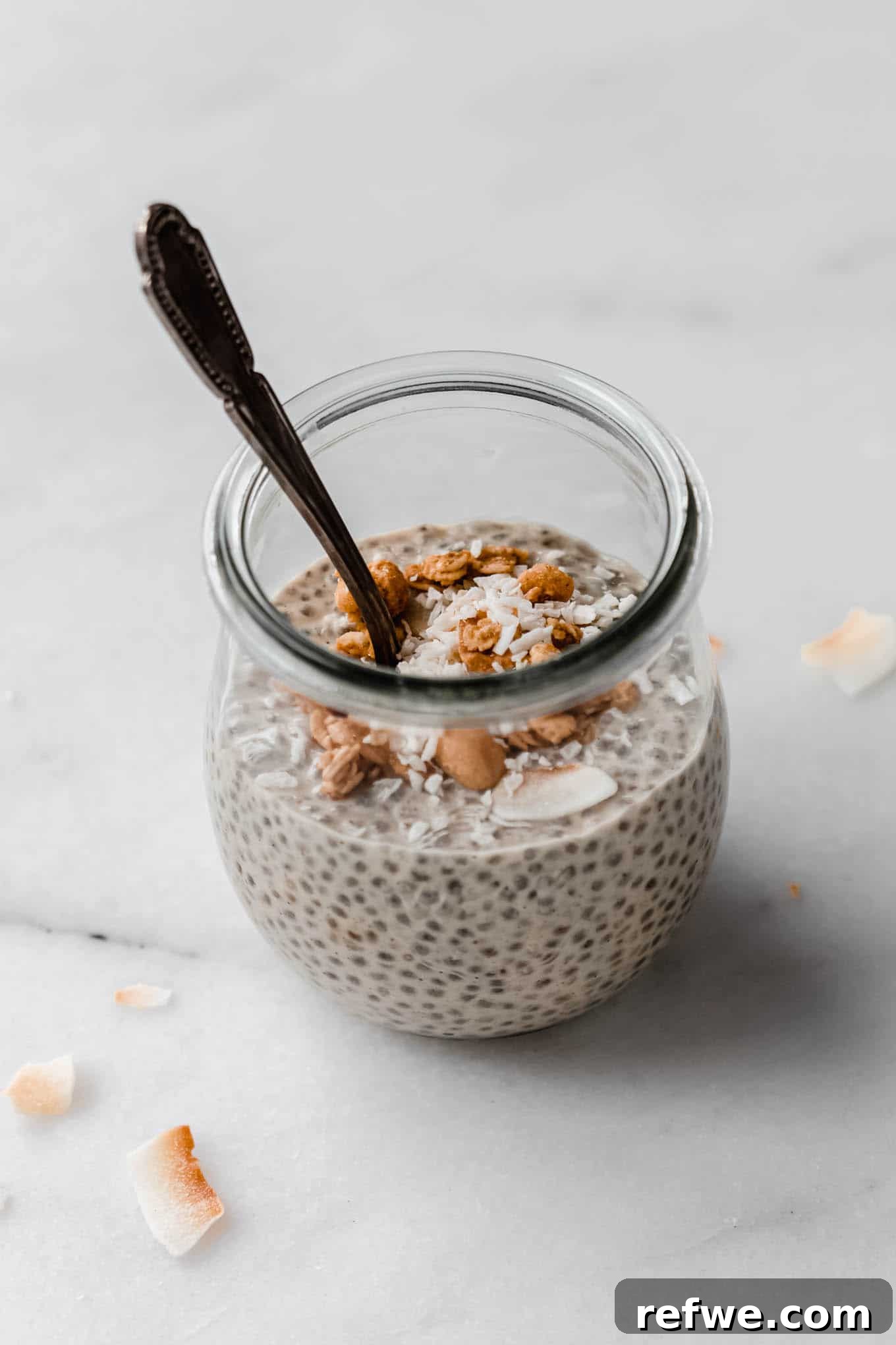 Creamy Peanut Butter Chia Pudding 8 A beautiful jar of peanut butter chia pudding with a spoon, ready to be enjoyed as a wholesome breakfast or snack.