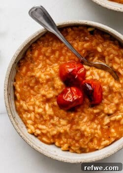 a bowl of tomato risotto topped with roasted tomatoes
