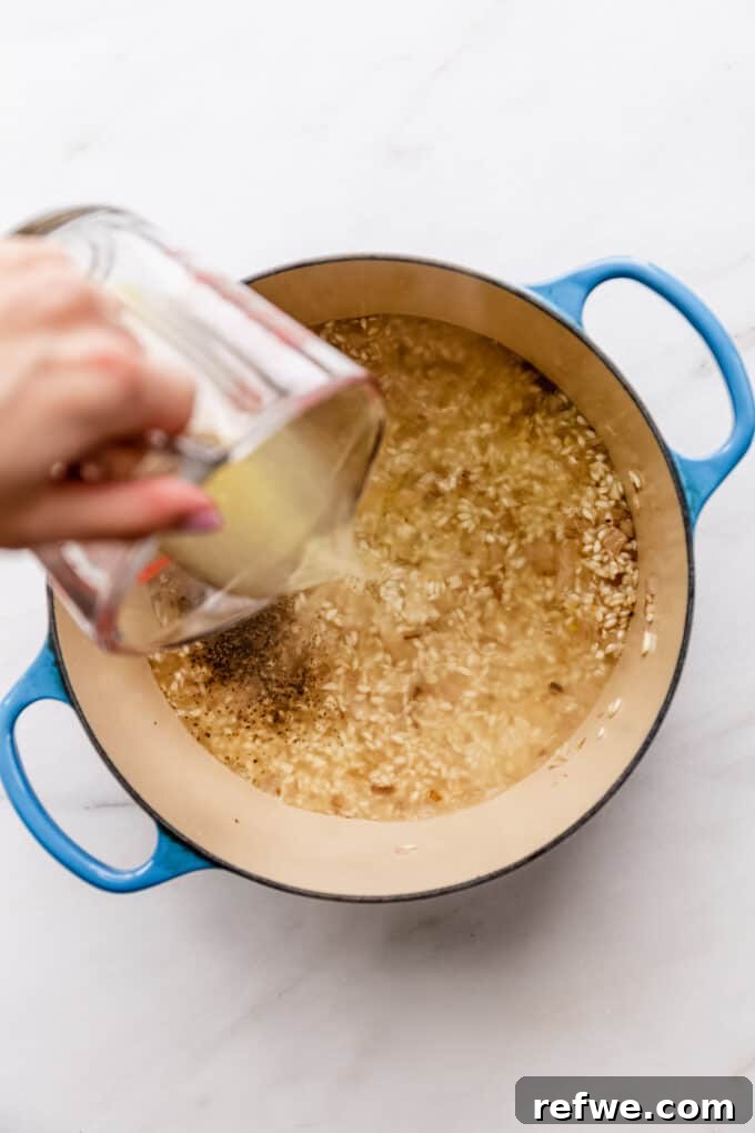 Romantic Tomato Risotto for Two 6 Pouring hot vegetable stock into the rice