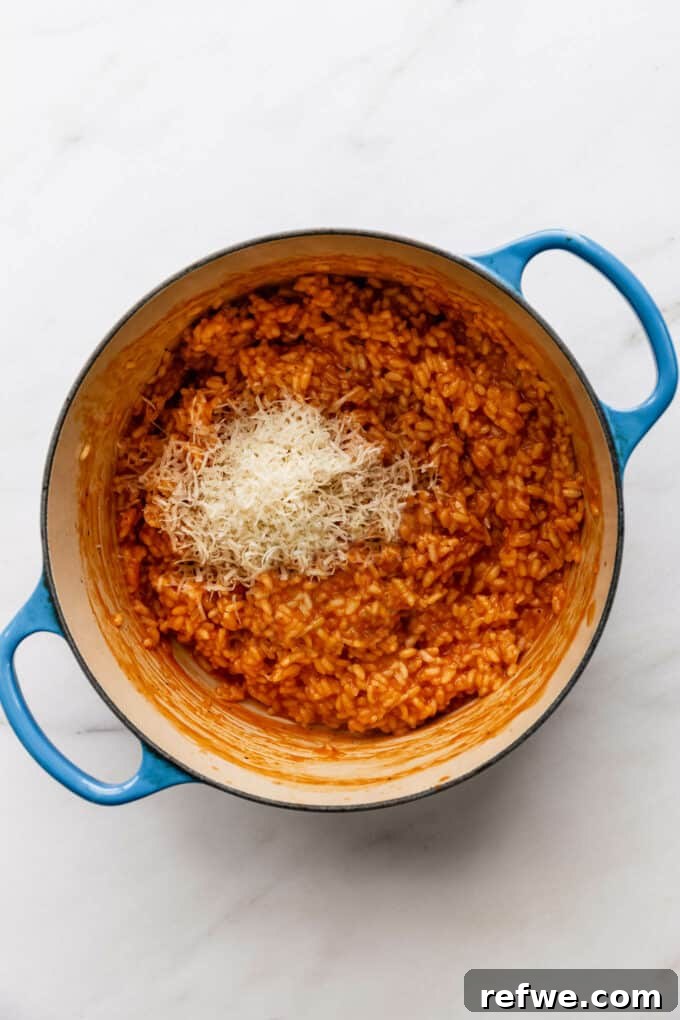 Romantic Tomato Risotto for Two 8 Stirring Parmesan cheese and basil into tomato risotto