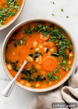 white bean and kale soup topped with chopped parsley