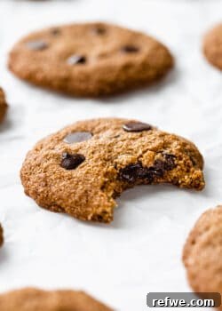 an almond flour chocolate chip cookie with a bite taken from it
