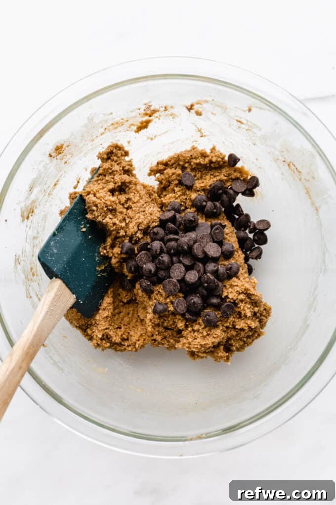 almond flour cookie dough with chocolate chips being stirred in