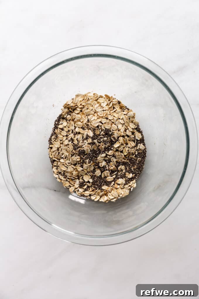 Dreamy Cookie Dough Oats 4 Dry ingredients: oats and chia seeds in a mixing bowl, ready for preparation.