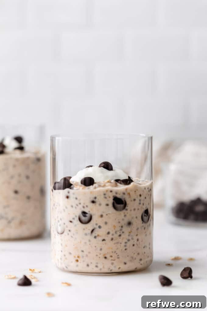 Dreamy Cookie Dough Oats 9 Two finished cups of cookie dough overnight oats, garnished with extra chocolate chips and a dollop of yogurt.