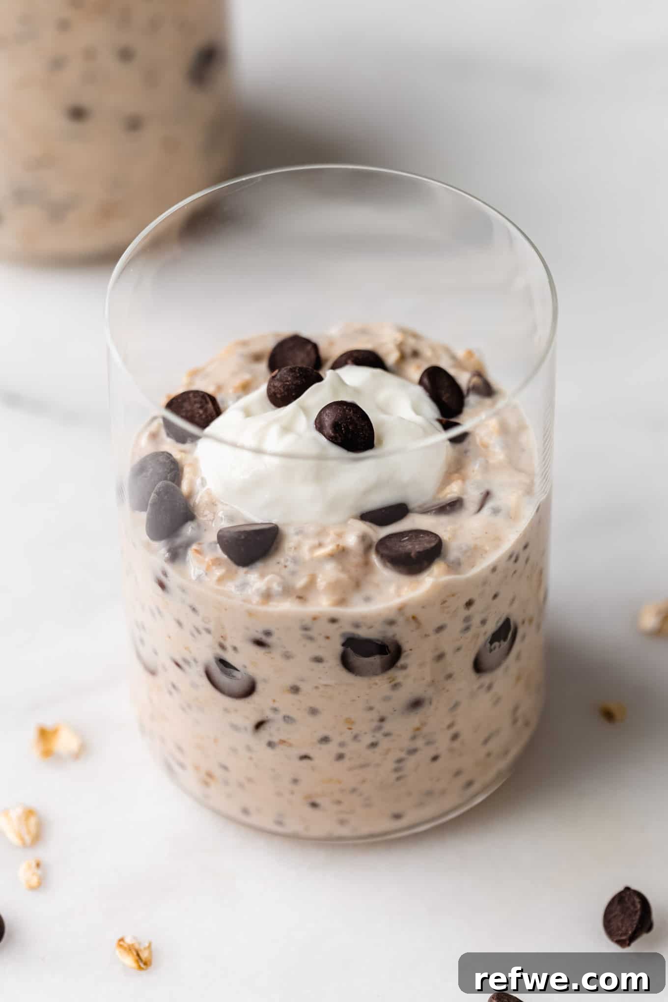 Dreamy Cookie Dough Oats 10 A beautifully presented cup of cookie dough overnight oats, generously topped with an array of chocolate chips, ready for a delicious breakfast.