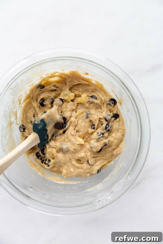 Wholesome Banana Oat Muffins 11 Banana muffin batter thoroughly mixed with chocolate chips, ready to be scooped.