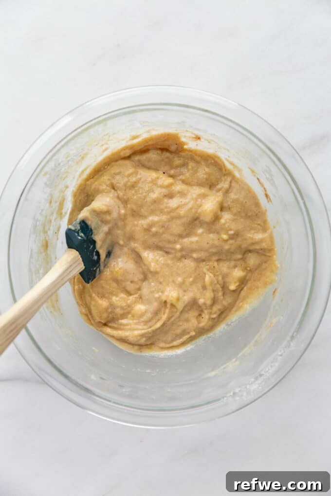 Wholesome Banana Oat Muffins 9 Muffin batter with oat flour, lightly mixed and still showing some dry spots, in a mixing bowl.