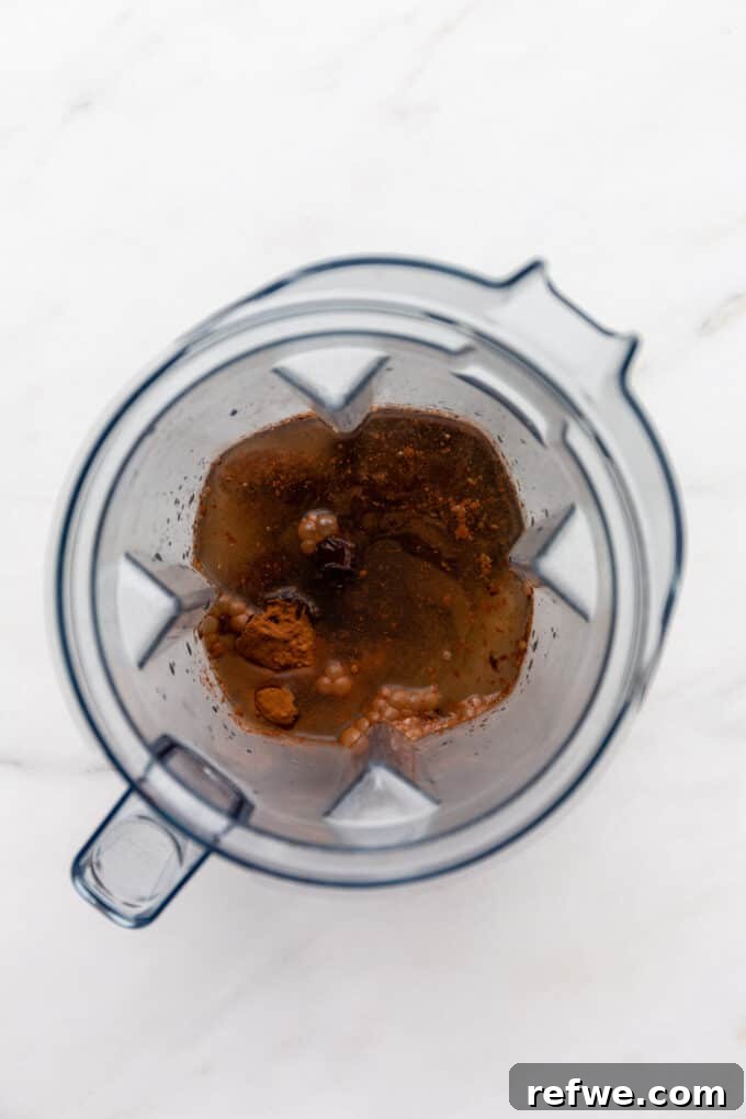 All the vegan chocolate pudding ingredients in the blender, before blending, showcasing their texture and readiness for transformation.