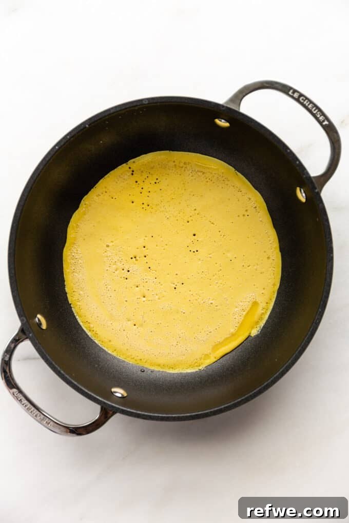 chickpea flour omlette batter in a pan