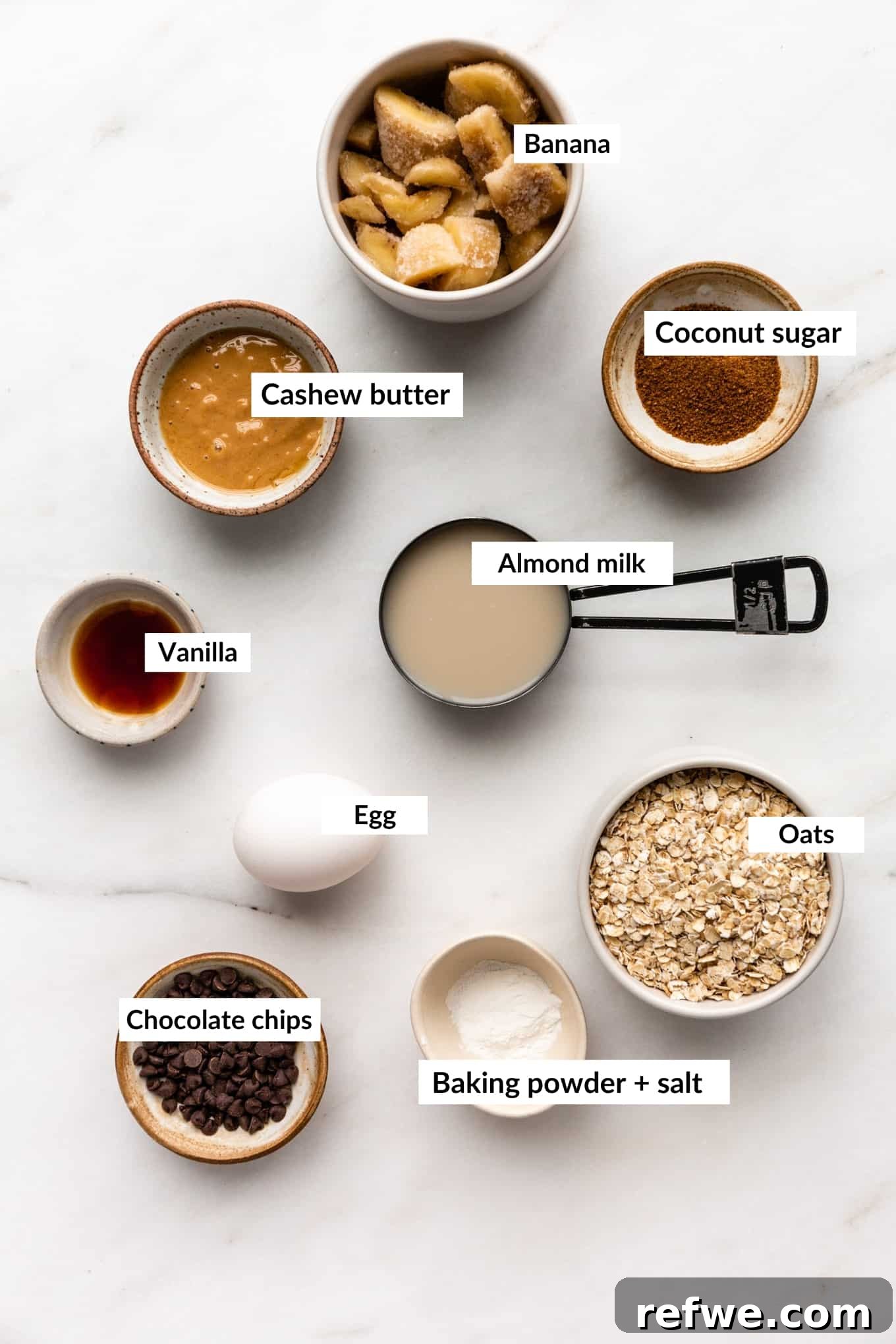 Cookie Dough Baked Oatmeal 3 A selection of raw ingredients for cookie baked oatmeal including oats, cashew butter, banana, milk, and chocolate chips