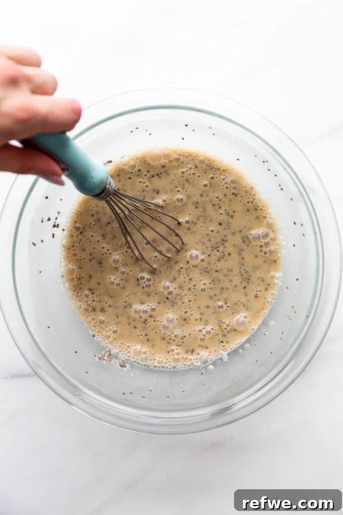 Decadent Coffee Chia Delight 5 Coffee chia pudding mixture being whisked in a mixing bowl until it thickens slightly.