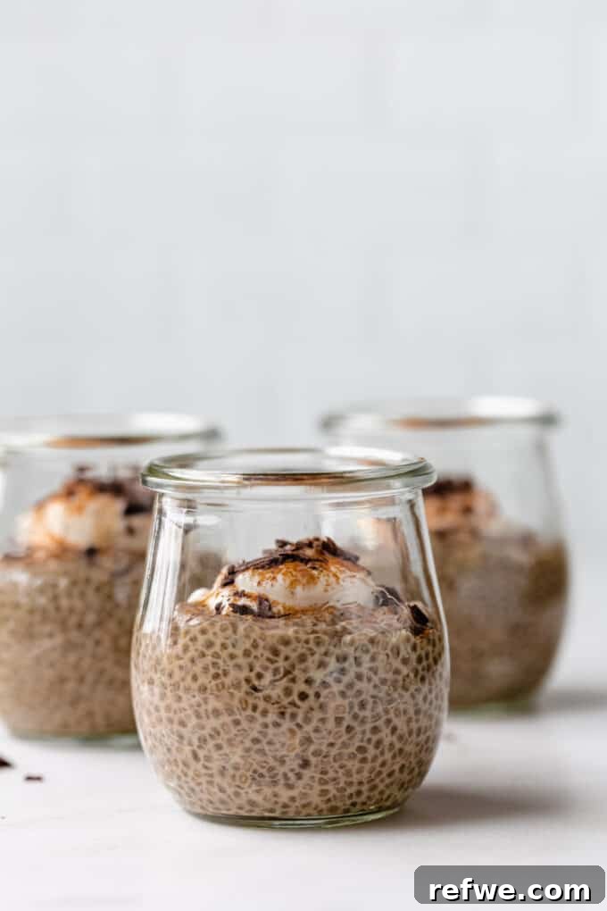 Decadent Coffee Chia Delight 7 Three small jars of coffee chia pudding, beautifully topped with creamy yogurt and a sprinkle of cinnamon, ready to be enjoyed.