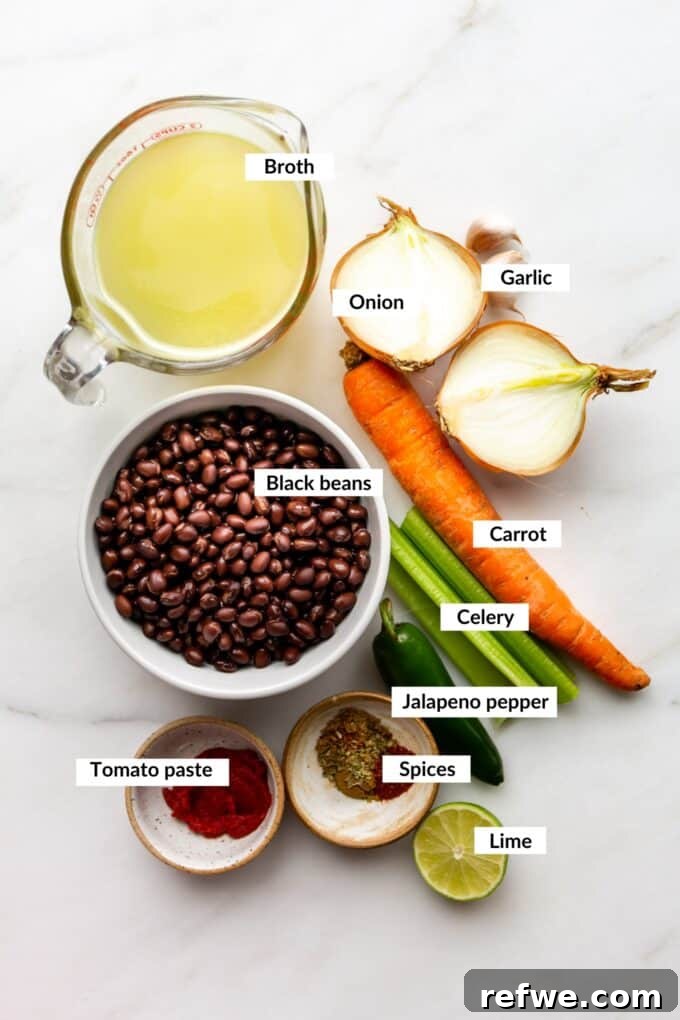 Fresh Ingredients for Vegan Black Bean Soup A vibrant selection of fresh ingredients laid out for making black bean soup, including black beans, vegetables, and spices.