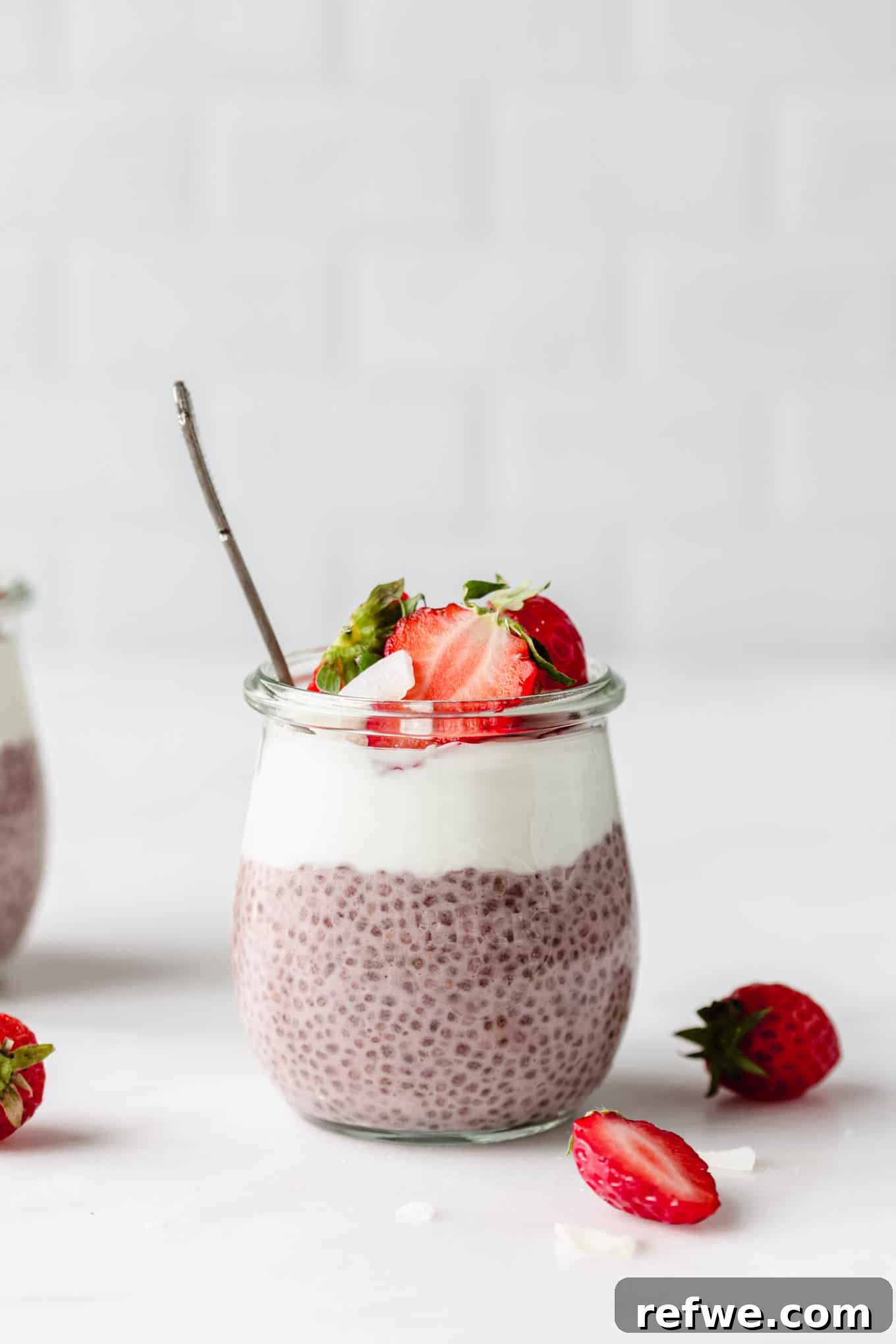 Strawberry Chia Delight 9 A jar of strawberry chia pudding topped with creamy yogurt, fresh strawberries, and a sprig of mint