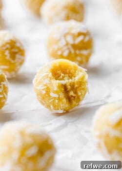 a lemon bliss ball with a bite taken out of it